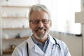 Smiling professional older man doctor looking at camera, closeup portrait Royalty Free Stock Photo