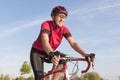 Smiling Professional Road Cyclist During Ride on Bike Outdoors. Royalty Free Stock Photo