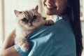 Smiling Professional Veterinarian Holding Cute Cat