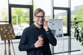 Smiling programmer with coffee talking on