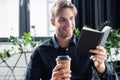 Smiling programmer looking at notebook and