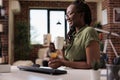 Smiling programmer taking a break from remote work holding a cup of cofee or tea