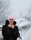 Smiling and prosperous woman on the snow-covered bridge Royalty Free Stock Photo