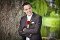 Smiling proud groom - young male in suit