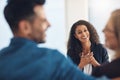 Smiling psychologist looking happy, cheerful and successful after counseling a couple in routine marriage therapy in a Royalty Free Stock Photo