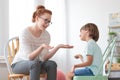 Psychotherapist talking with autistic boy Royalty Free Stock Photo