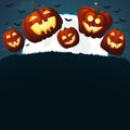 Smiling pumpkins jumping on a grass. Spooky dark blue background.