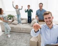 Smiling realtor with keys on the background of a new apartment Royalty Free Stock Photo