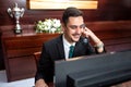 Smiling receptionist tending to hotel needs