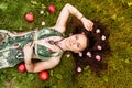 Smiling red-haired alternative girl with shaved walks in a Sunny Apple orchard on a Sunny summer day Royalty Free Stock Photo