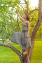 Smiling red-haired alternative girl with shaved walks in a Sunny Apple orchard on a Sunny summer day Royalty Free Stock Photo