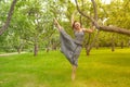 Smiling red-haired alternative girl with shaved walks in a Sunny Apple orchard on a Sunny summer day Royalty Free Stock Photo