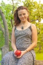 Smiling red-haired alternative girl with shaved walks in a Sunny Apple orchard on a Sunny summer day Royalty Free Stock Photo