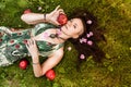 Smiling red-haired alternative girl with shaved walks in a Sunny Apple orchard on a Sunny summer day Royalty Free Stock Photo