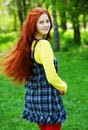 Smiling redhaired girl, outdoors