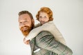 Smiling redhead boy piggybacking on father Royalty Free Stock Photo