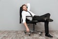 Smiling relaxed businessman resting in office chair
