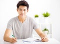 Smiling relaxed young man reading book