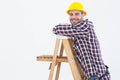 Smiling repairman climbing ladder