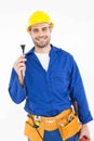 Smiling repairman holding electric plug