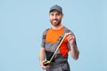 Smiling repairman worker in uniform holding measure tape and looking camera Royalty Free Stock Photo