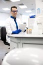 Smiling research scientist using digital tablet in laboratory