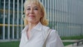 Smiling retired businesswoman walking street closeup. Happy woman looking camera Royalty Free Stock Photo