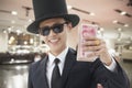 Smiling Rich Man with a Big Hat Holding and Showing Off His Money Royalty Free Stock Photo