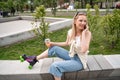 smiling roller skater with cocktail sitting