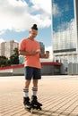 Smiling roller skater using smartphone and