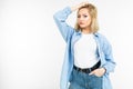 Smiling romantic girl in a stylish blue denim shirt posing on a white background with copy space