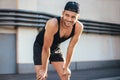 Smiling runner relaxing after workout