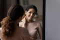 Smiling 30s hispanic caucasian woman looking at mirror. Royalty Free Stock Photo