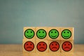 smiling and sad emoticons on a blue background. satisfaction concept Royalty Free Stock Photo