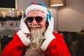 Santa claus listening to music on headphones at home Royalty Free Stock Photo