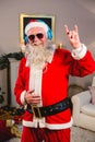 Santa claus listening to music on headphones at home Royalty Free Stock Photo
