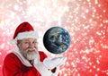 Smiling santa claus pretending to hold globe Royalty Free Stock Photo