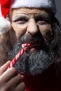 Smiling santa with a grin, looking at the camera, evil santa dead - mummy. Christmas horror concept