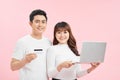 Smiling satisfied couple buying online with credit card at home