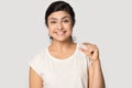 Smiling satisfied Indian girl showing little size gesture with fingers Royalty Free Stock Photo