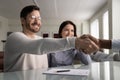 Smiling satisfied millennial man shake hands with insurance agent Royalty Free Stock Photo