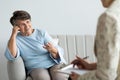 Smiling satisfied senior woman talking to a psychotherapist