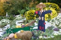 Smiling scarecrow in a vegetable garden in a countryside.