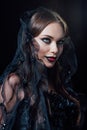 Smiling scary vampire girl in black gothic dress and veil Royalty Free Stock Photo