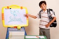 Smiling school boy pointing at white board