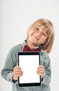 Smiling School boy in shirt with red bow tie, holding tablet computer and green apple in white background Royalty Free Stock Photo