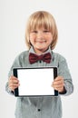 Smiling School boy in shirt with red bow tie, holding tablet computer in white background