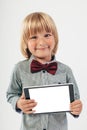 Smiling School boy in shirt with red bow tie, holding tablet computer in white background