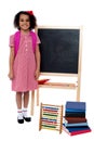 Smiling school girl standing near the blackboard Royalty Free Stock Photo