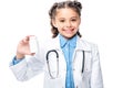 smiling schoolchild in costume of doctor holding bottle of pills Royalty Free Stock Photo